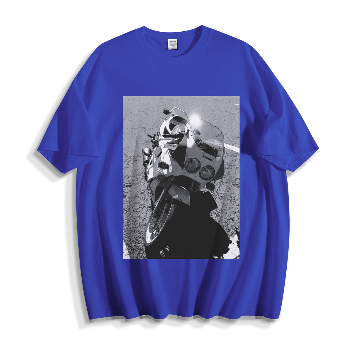 A flat lay of a blue 90s monochrome motorcycle photography tee, combining a bold primary colorway with a gritty vintage racing apparel graphic.