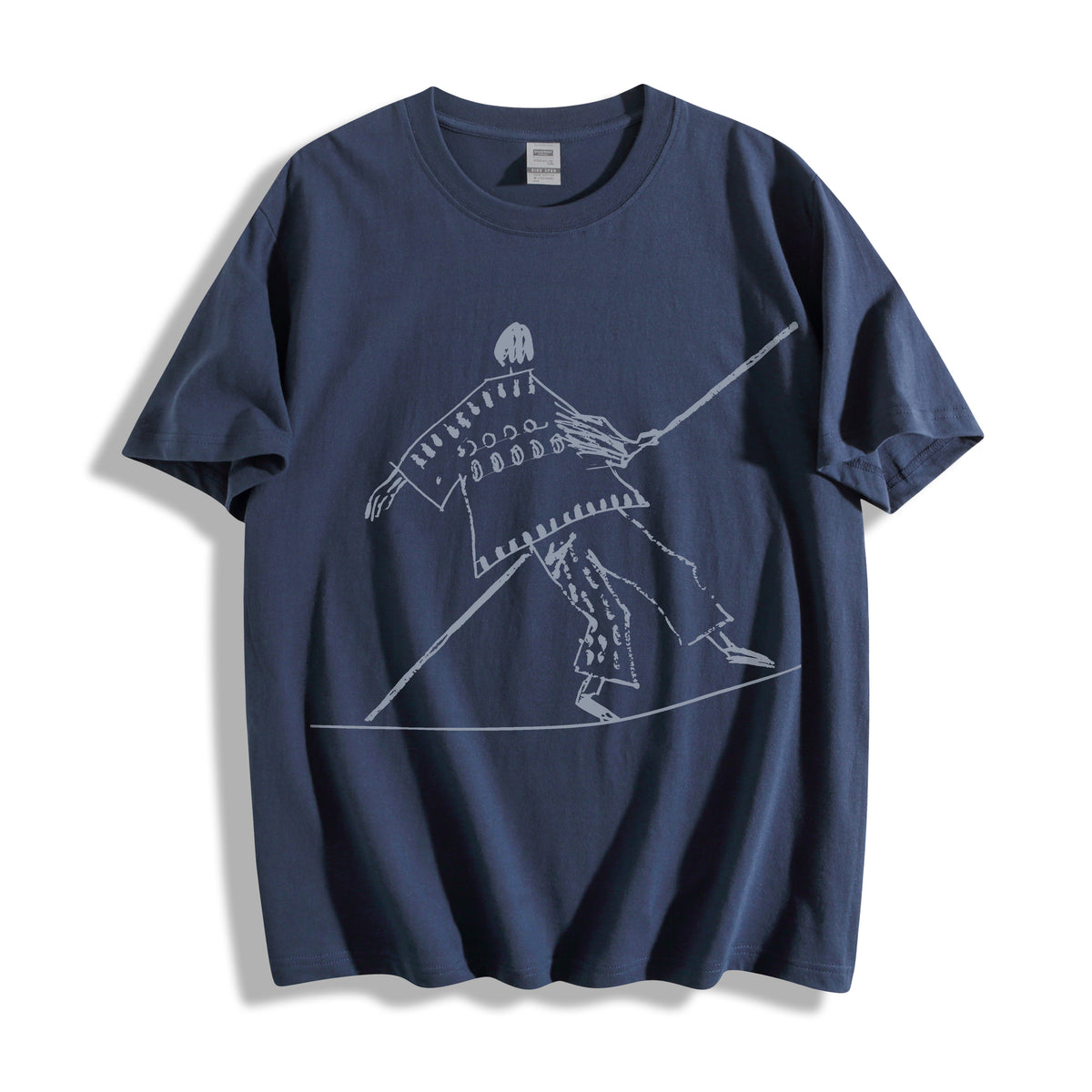 Flat lay product photography of a vintage navy oversized t-shirt showcasing a minimalist tightrope walker high wire line art graphic.
