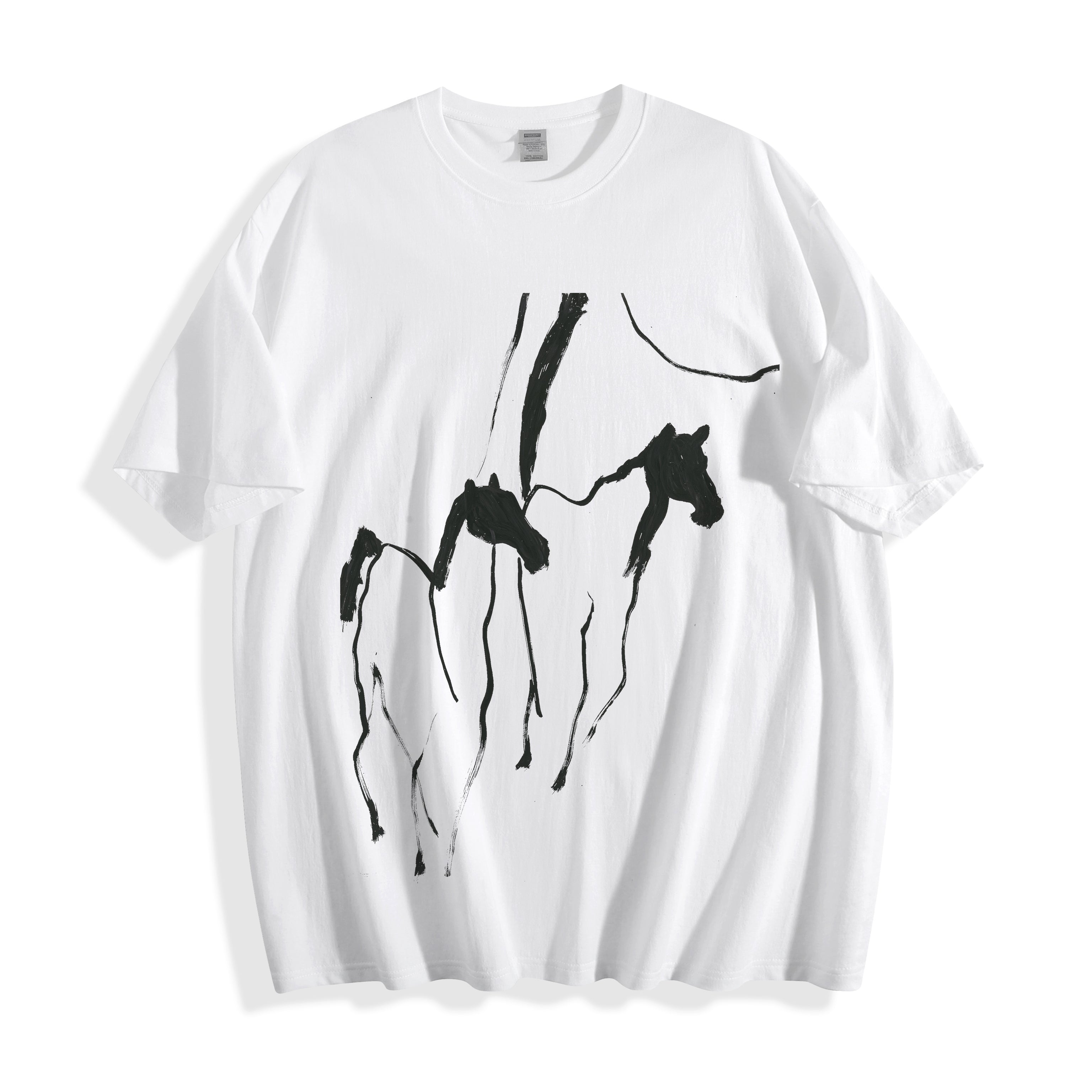 Clean flat lay product shot of a white oversized t-shirt featuring a high-contrast black abstract brush wild horses illustration.
