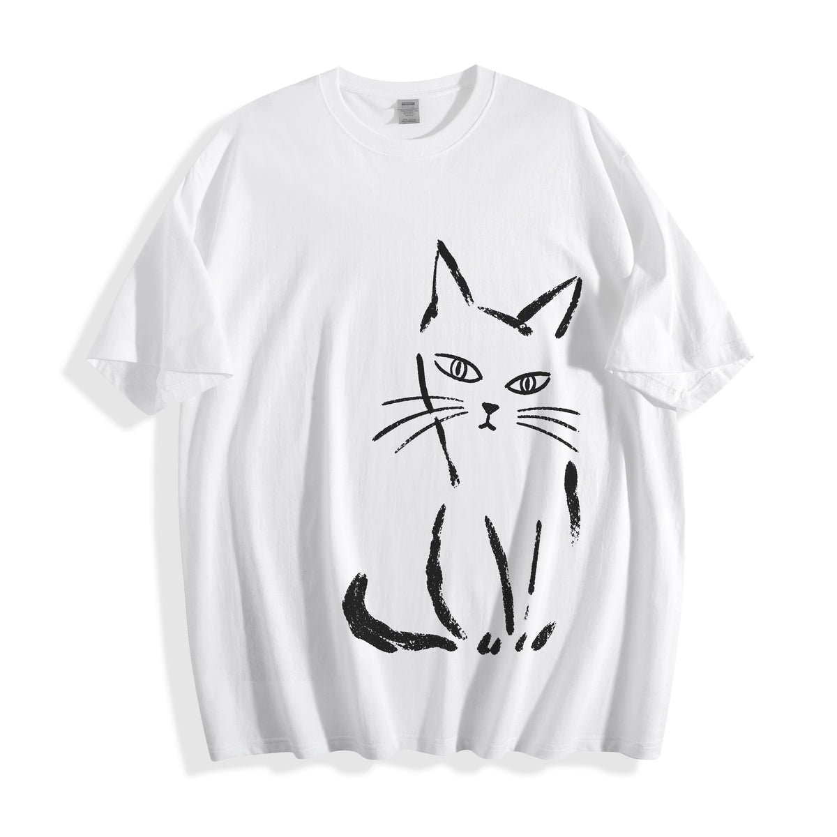 Clean flat lay product shot of a white oversized t-shirt featuring a high-contrast black raw paint stroke feline illustration.