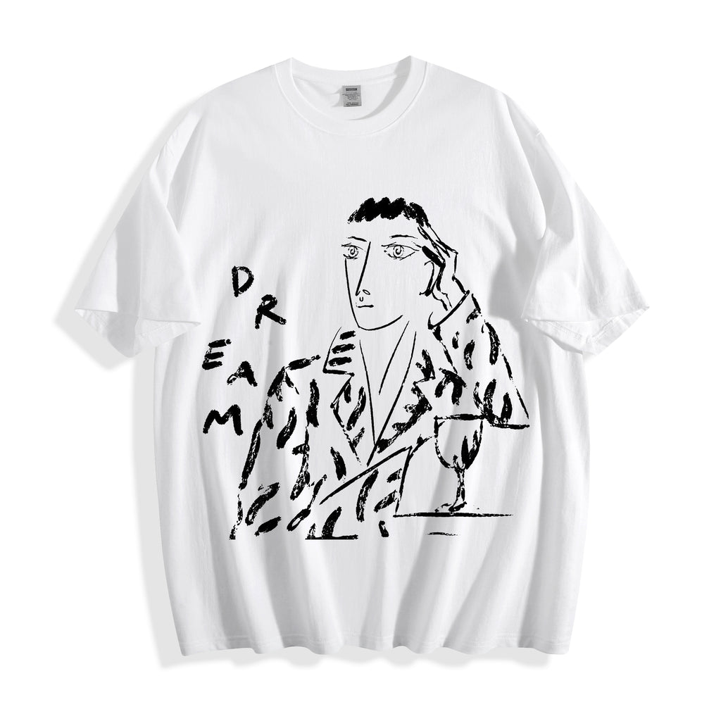 A white short-sleeve crewneck t-shirt featuring a black graphic print of a stylized face and figure with the word 'DREAM' integrated into the design, displayed on a clean white background.